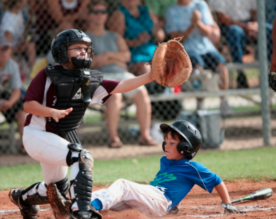 Kid crossing homeplate